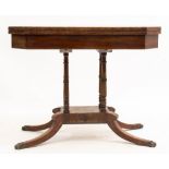 AN EARLY VICTORIAN MAHOGANY FOLDOVER CARD TABLE with canted corners, four turned column supports and