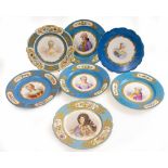 SEVEN FRENCH PORCELAIN CABINET PLATES all with a blue glaze, floral borders and central portraits,