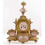 A 19TH CENTURY CONTINENTAL PORCELAIN MOUNTED GILT SPELTER MANTLE CLOCK the case surmounted by an urn