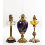 A VICTORIAN OIL LAMP with a double burner, blue enamelled and gilded base on a brass foot 45cm in