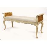 A WHITE PAINTED 18TH CENTURY FRENCH STYLE WINDOW SEAT with caned ends and cabriole legs, 133cm