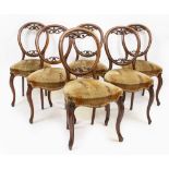 A SET OF SIX VICTORIAN MAHOGANY BALLOON BACK DINING CHAIRS with upholstered seats and cabriole legs,