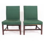 A PAIR OF ANTIQUE MAHOGANY FRAMED GREEN UPHOLSTERED CHAIRS with sabre back legs standing on