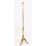 A BRASS LAMP STANDARD with cast tripod base and paw feet 150cm high overall