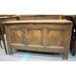A LATE 17TH / EARLY 18TH CENTURY SIX PLANK OAK COFFER with panel decoration, standing on stile feet,