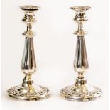 A PAIR OF WHITE METAL CANDLESTICKS with shell and scroll decoration and fluted stems 25cm high