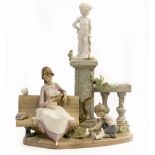 A LLADRO PORCELAIN SCULPTURE model number 5425 'Studying in the Park', 26cm wide x 30cm high