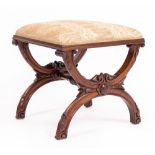A VICTORIAN WALNUT 'X' FRAMED DRESSING TABLE STOOL with carved decoration 45cm wide x 42cm deep x
