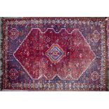 AN EASTERN RED GROUND WOOLLEN RUG 203cm x 310cm; a further rust ground rug (2)