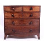 AN EARLY 19TH CENTURY MAHOGANY TWO SHORT AND THREE LONG DRAWER CHEST standing on splayed feet, 108cm