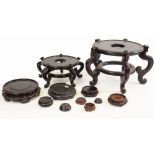 A COLLECTION OF ORIENTAL CHINESE HARDWOOD STANDS the largest 38cm diameter