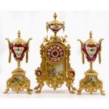 A 20TH CENTURY ORNAMENTAL POSSIBLY FRENCH CLOCK GARNITURE with indistinctly signed movement and