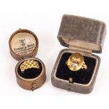 AN 18CT GOLD SIGNET RING decorated with a grenade together with an 18ct gold ring with knot