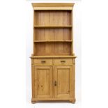 AN EARLY 20TH CENTURY PINE DRESSER with plate rack above two short drawers and two cupboard doors