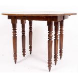 AN EARLY 20TH CENTURY MAHOGANY DROP LEAF EXTENDING TABLE on fluted legs terminating in porcelain