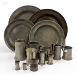 AN OLD PEWTER CHARGER 38cm diameter together with three further pewter dishes, various pewter
