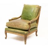 A FRENCH BEECHWOOD LIBRARY ARMCHAIR with green leather upholstery and loose squab cushions, 68cm