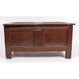 AN EARLY 18TH CENTURY OAK COFFER with panel decoration, standing on stile feet, 118cm wide x 50cm