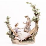 A LLADRO PORCELAIN SCULPTURE Ladies on a hammock under a tree, 40cm wide x 44cm high