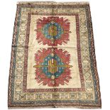 A TURKISH MILAS DESIGN SMALL CARPET with a cream ground, banded border and geometric decoration,
