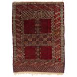 AN ANTIQUE TEKKE TURKOMAN RED GROUND RUG with stylised decoration and a latch hook surround 116cm