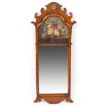 A 19TH CENTURY WALNUT FRET FRAMED WALL MIRROR with a floral painted panel 45cm wide x 108cm high