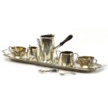 A MINIATURE SILVER TEA SERVICE with pot (lid deficient), two tea cups, cream jug and sucrier on