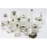 A COLLECTION OF ANTIQUE AND LATER SILVER TOPPED CUT GLASS BOTTLES