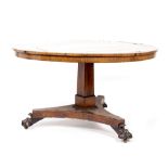 A REGENCY ROSEWOOD AND BRASS INLAID CIRCULAR BREAKFAST TABLE with a triform base and paw feet