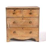 A SMALL PINE CHEST of two short and two long drawers with brass handles and bracket feet 66.5cm wide