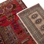 TWO PRAYER MATS to include a Middle Eastern example on a red ground with repeating motif border