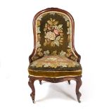 A VICTORIAN TAPESTRY UPHOLSTERED LOW CHAIR with cabriole legs and brass castors 58cm wide x 60cm