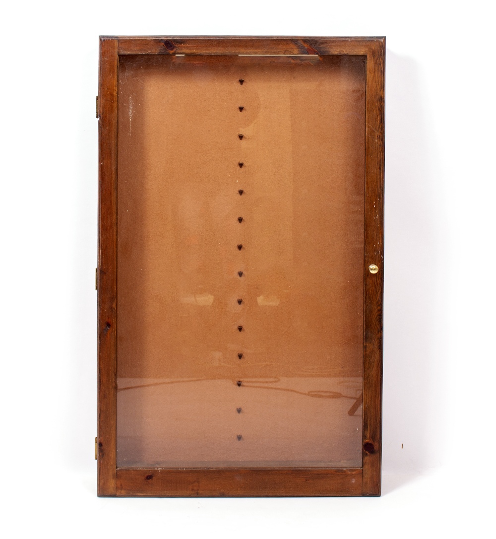 A STAINED PINE GLAZED WALL MOUNTED DISPLAY CABINET with glass shelves 63cm wide x 9cm deep x 107cm