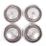 A SET OF FOUR 20TH CENTURY CHROME POSSIBLY CADILLAC WHEEL TRIMS with emblem, 42cm overall (4)