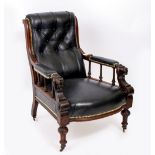 A VICTORIAN MAHOGANY FRAMED ARMCHAIR with black leather button upholstery, lions mask arms, turned