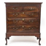 A CHEST OF DRAWERS ON STAND consisting of two short and three long drawers, standing on cabriole