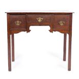 A GEORGE III OAK KNEEHOLE SIDE TABLE with three drawers and square legs 81cm wide x 43.5cm deep x