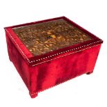 A RED VELVET UPHOLSTERED BOX with a foliate carved wooden top 93cm wide x 79cm deep x 53cm high