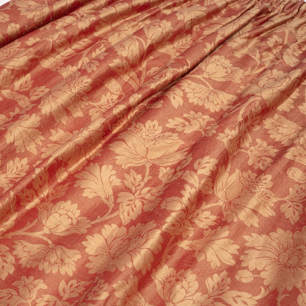 A PAIR OF 20TH CENTURY RAW SILK CURTAINS on a coral ground with peony decoration with gathered
