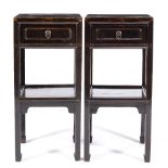 A PAIR OF BLACK LACQUERED CHINESE SIDE TABLES each with a single panelled door, the square legs