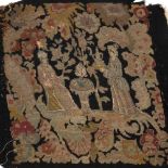 AN 18TH CENTURY NEEDLEWORK BLACK GROUND CHAIR COVER depicting figures either side of a table