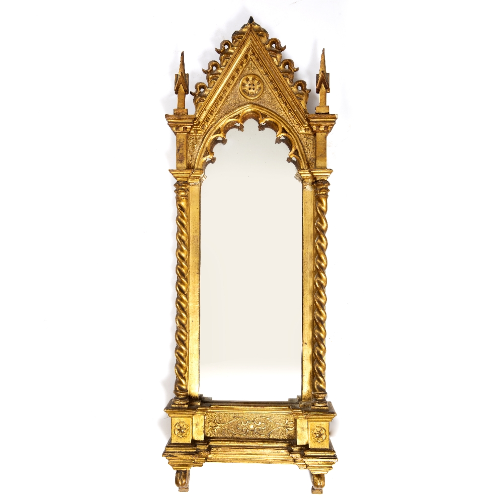 A 19TH CENTURY GILT CARVED WOOD WALL MIRROR in the Gothic style with architectural finials and