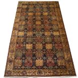 A DECORATIVE CARPET with fifty five rectangular panels, each with stylised floral decoration set