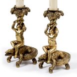 A PAIR OF LATE 19TH / EARLY 20TH CENTURY GILT METAL CANDLESTICKS in the form of a Putti holding