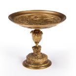 A 19TH CENTURY GILT BRASS TAZZA decorated with classical scenes, the stem with Rams Head masks and