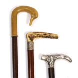 A HARDWOOD WALKING CANE with an Art Nouveau style white metal crutch handle 89cm in length, a late