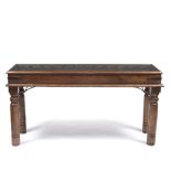 A HARDWOOD CONSOLE TABLE constructed from an Indian door with carved decoration and inset glazed top