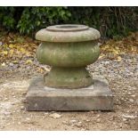 A CARVED STONE AND MARBLE URN on a square plinth 33cm diameter x 37cm high