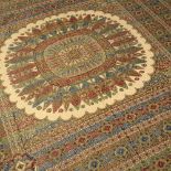 AN ORIENTAL POSSIBLY MIDDLE EASTERN SILK TABLE COVER OR BEDSPREAD with central radiating motif on