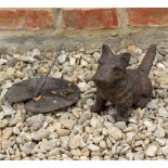 A CAST IRON MODEL OF A SCOTTIE DOG in a seated position and a bronze gnomon in the form a lilypad (